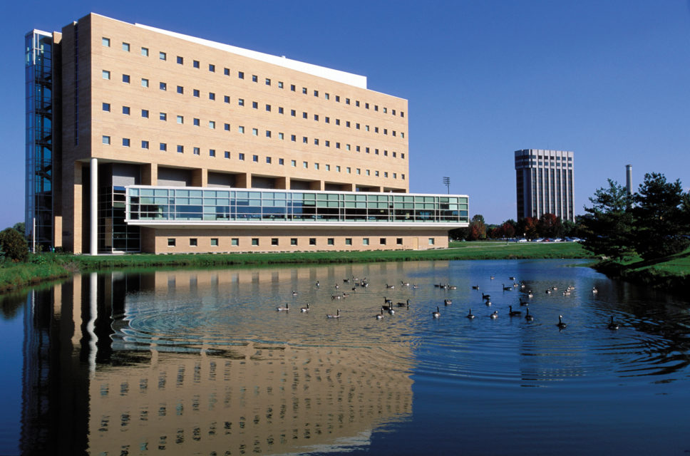 Rennebohm Hall is reflected in the pond at the northwest side of the building